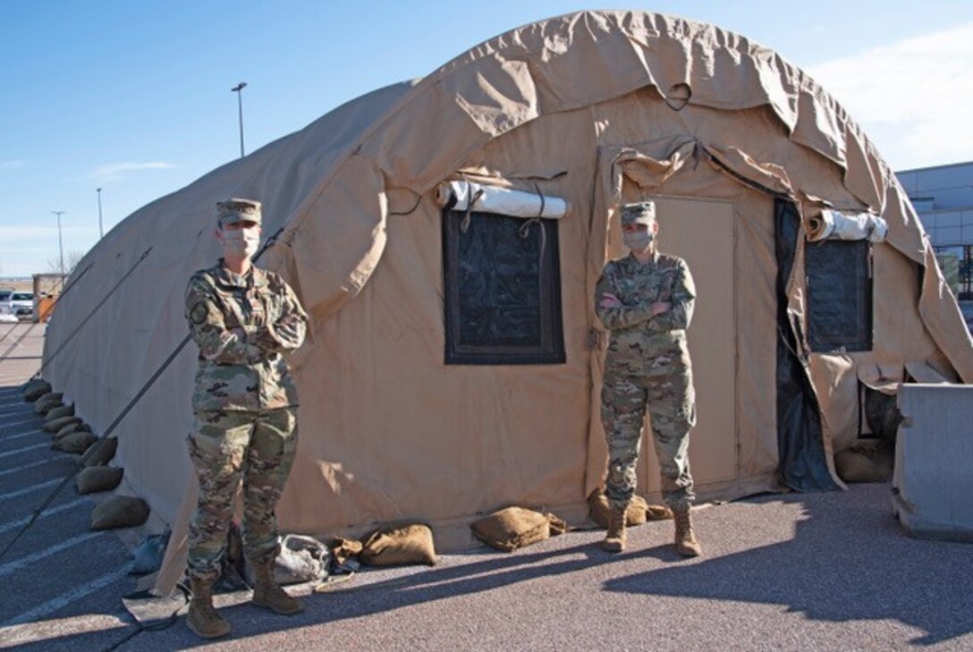 PETERSON AIR FORCE BASE, Colo. –Capt. Lorna Neeley, 21st Medical Group patient administration team chief, and Capt. Jennifer Shoemake, 21 MDG clinical team chief, assists with the drive-thru pharmacy April 15, 2020. Shoemake and Neeley have been vital in the efforts to stop the spread of COVID-19 with the stand-up of the Point of Testing Center and the more recent drive-thru pharmacy. (Air Force photo by Staff Sgt. Alexandra M. Longfellow)