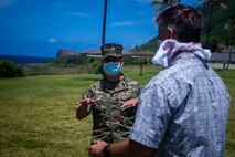 U.S. Marine Corps Col. Raul Lianez, commanding officer, Marine Corps Base Hawaii, speaks to Sen. Gil Riviere, (D-HI), during a tour of MCBH, Apr. 15, 2020. Sen. Jarrett Keohokalole, (D-HI), and Riviere visited the base to discuss the COVID-19 response and toured the installation to observe how prepared and resilient the installation and MCBH community members are. MCBH is currently in Health Protection Condition Charlie, which is where the military and medical leaders are taking necessary precautions to prevent or respond to a potential outbreak. (U.S. Marine Corps photo by Cpl. Matthew Kirk)