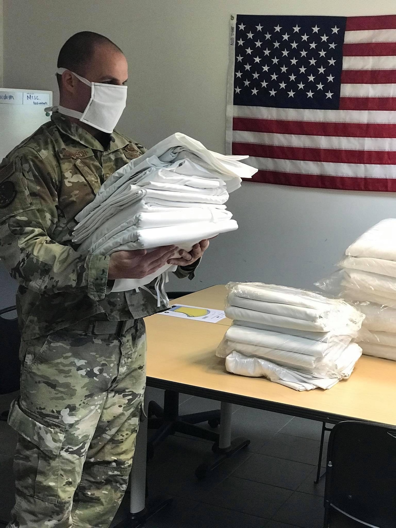 U.S. Air Force Tech Sgt. Kevin Robinson, 52nd Operations Support Squadron NCOIC of aircrew flight equipment quality assurance, carries fabric at Spangdahlem Air Base, Germany, April 13, 2020. Robinson says he was always taught to help people in need no matter the circumstance. “We need to show others that someone is looking out for them and we as a community need to protect each other from this disease” he added. Public health protection is the 52nd Fighter Wing’s top priority, and the wing continues to ensure that personnel and community members have the most up-to-date information on appropriate measures to prevent potential spread of COVID-19. (52nd Operations Support Squadron courtesy photo)