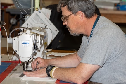 Norfolk Naval Shipyard’s (NNSY) Sail Loft personnel sewed facemasks to be delivered to the workforce.  As a temporary solution while NNSY’s Supply Department worked to order the necessary amount of COVID-19 specific Personal Protective Equipment (PPE), the Sail Loft produced more than 4,500 facemasks for project team members as well as support staff.