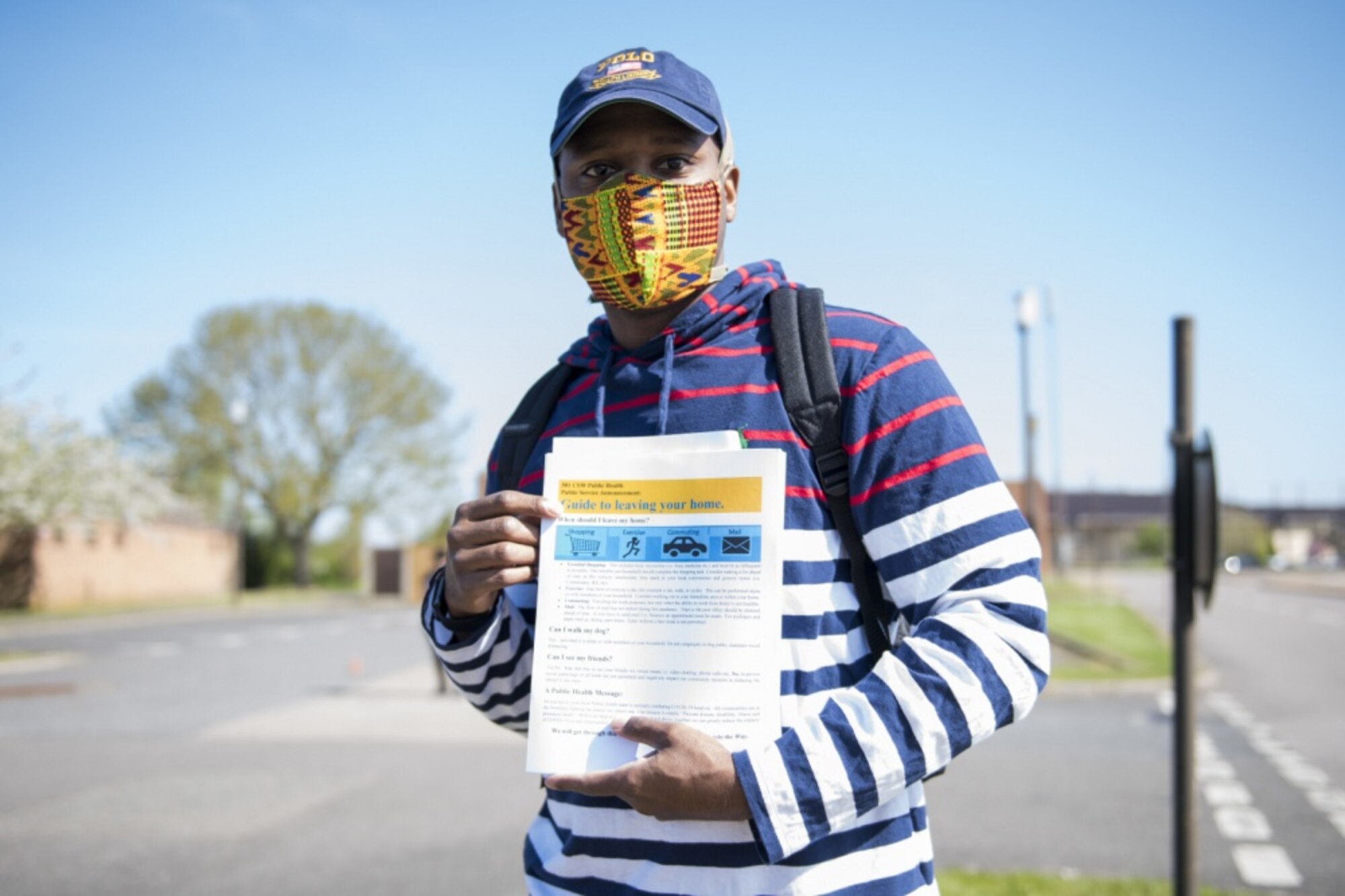 Dominique Lockley, a volunteer, poses for a photo holding an information handout at RAF Alconbury, England, April 15, 2020. Volunteers made 232 cloth face masks, which were given to community members at a drive thru to prevent the spread of COVID-19. (U.S. Air Force photo by Airman 1st Class Jennifer Zima)