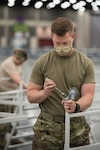 Capt. Jason Selby of the Kentucky Air National Guard’s 123rd Civil Engineer Squadron sets up hospital beds and clinical space at the Kentucky Fair and Exposition Center in Louisville, Ky., April 13, 2020. The alternate care facility can treat up to 288 patients recovering from COVID-19.