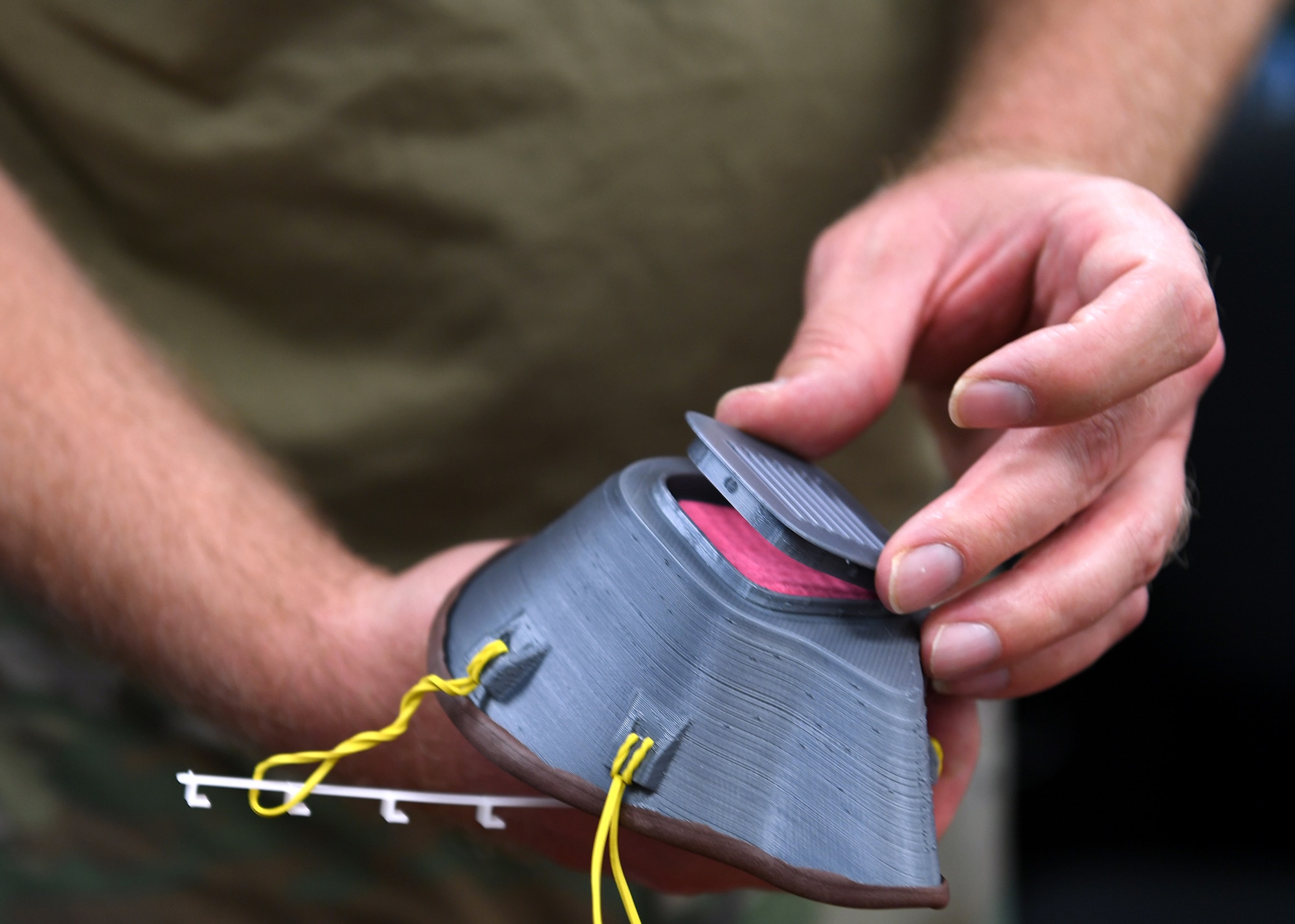 Staff Sgt. Paul Renker, 149th Maintenance Squadron hydraulics technician, shows a mask he made on his personal 3D printer for people in his unit who needed one after initial guidance came out about use and wear for Air Force personnel. (Air National Guard photo by Mindy Bloem)