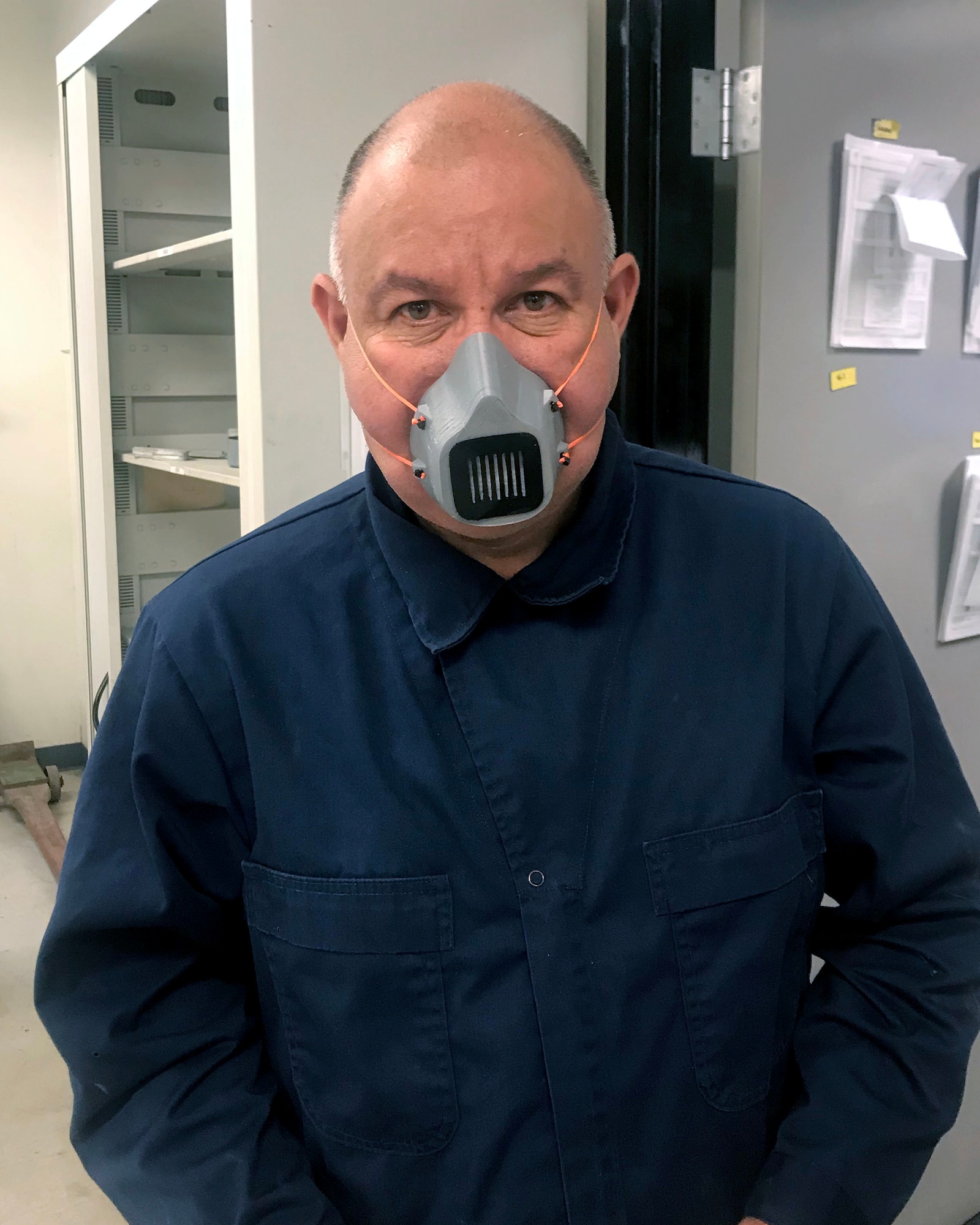 Master Sgt. Carlos Gil, 149th Maintenance Squadron aircraft metals technician, wears a mask he made on his personal 3D printer April 14 at Joint Base San Antonio-Lackland, Texas. Personnel from the unit’s shop have now begun printing solid-colored masks for members who need something to meet more specific guidance recently put in place for 149th Fighter Wing members. (Air National Guard photo by Mindy Bloem)