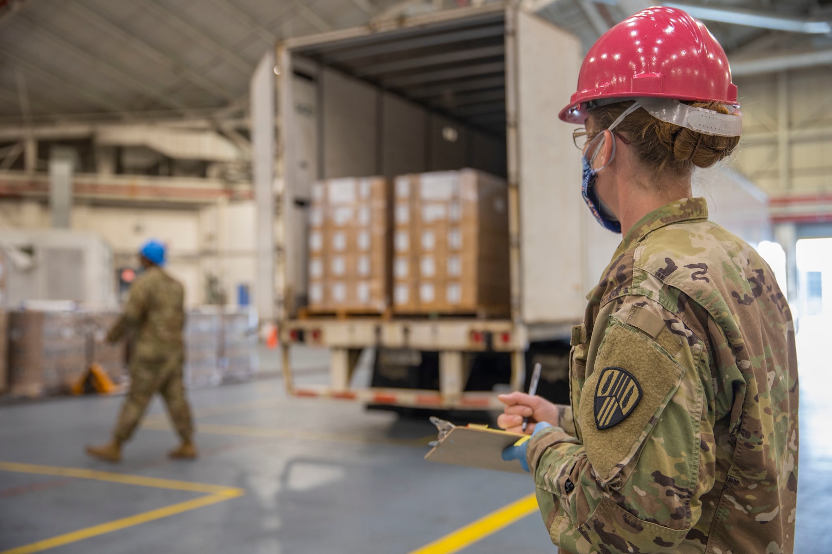 Staff Sgt. Stephanie Kimball assigned to the 1569th Transportation Company, 369th Sustainment Brigade, New York Army National Guard, documents an incoming supply shipment for the COVID-19 response at Stewart Air National Guard  Base in Newburgh, N.Y., April 14, 2020.