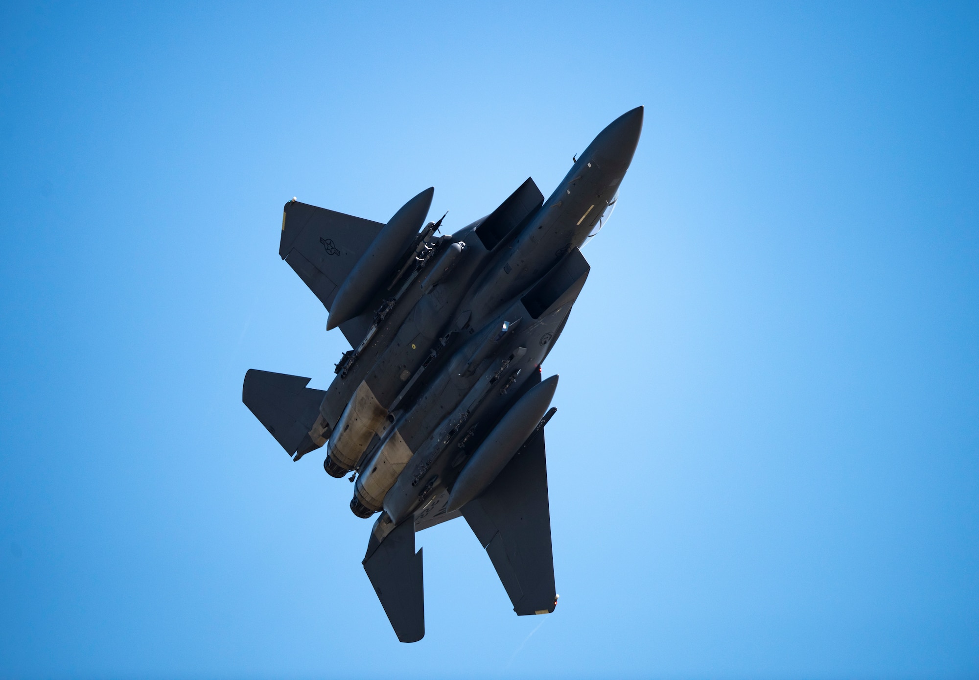 An F-15E Strike Eagle assigned to the 492nd Fighter Squadron performs a flight maneuver above Royal Air Force Lakenheath, England, April 15, 2020. Despite the current COVID-19 crisis, the 48th Fighter Wing has a critical mission of delivering combat air power when called upon that must continue. (U.S. Air Force photo by Airman 1st Class Madeline Herzog)