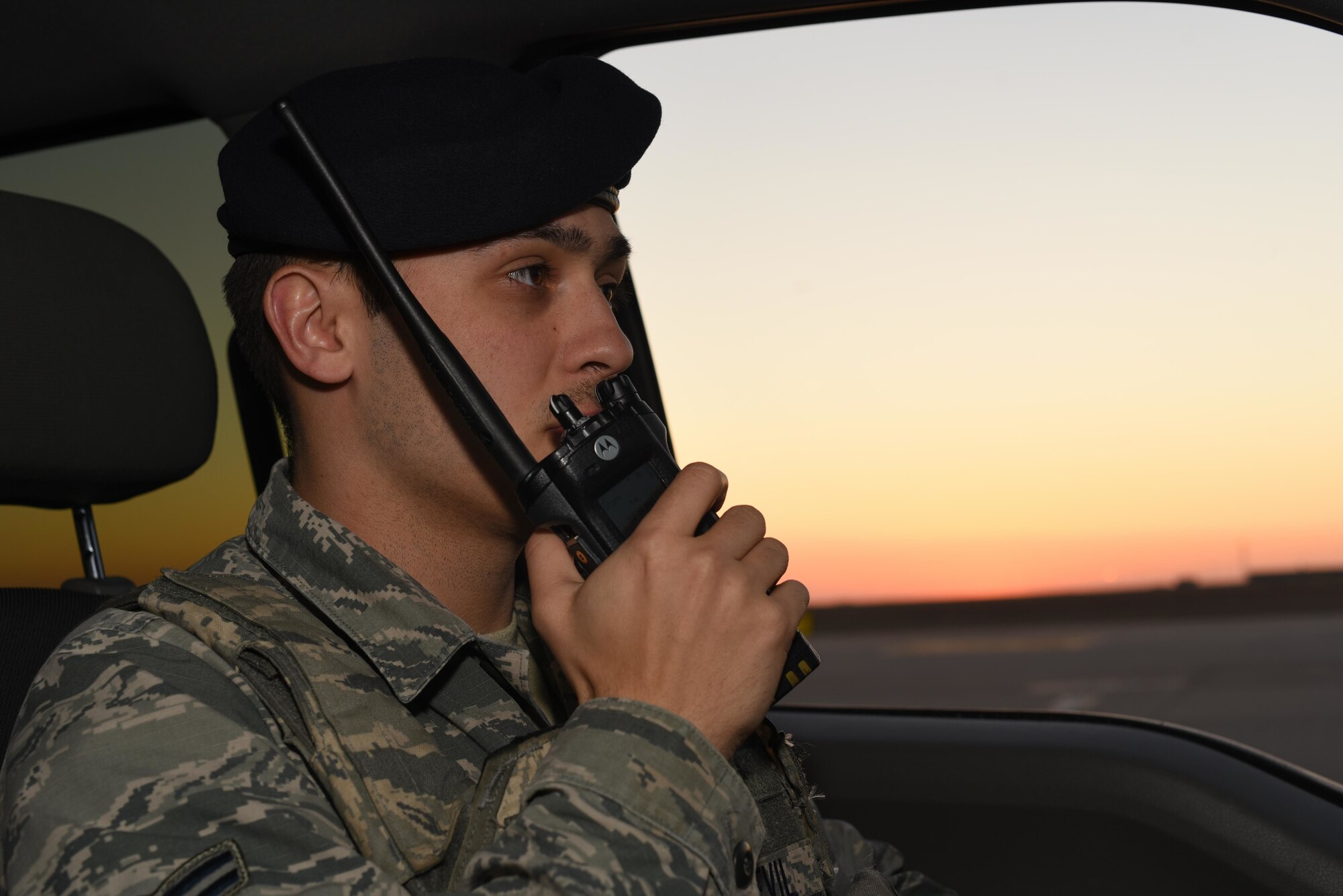 Airman 1st Class Tayler Sonnevil, 22nd Security Forces Squadron patrolman, radios into the SFS control center March 24, 2020, at McConnell Air Force Base, Kansas. Flight line security measures require Defenders to challenge personnel within restricted areas to validate their authorization. (U.S. Air Force photo by Senior Airman Alexi Bosarge)