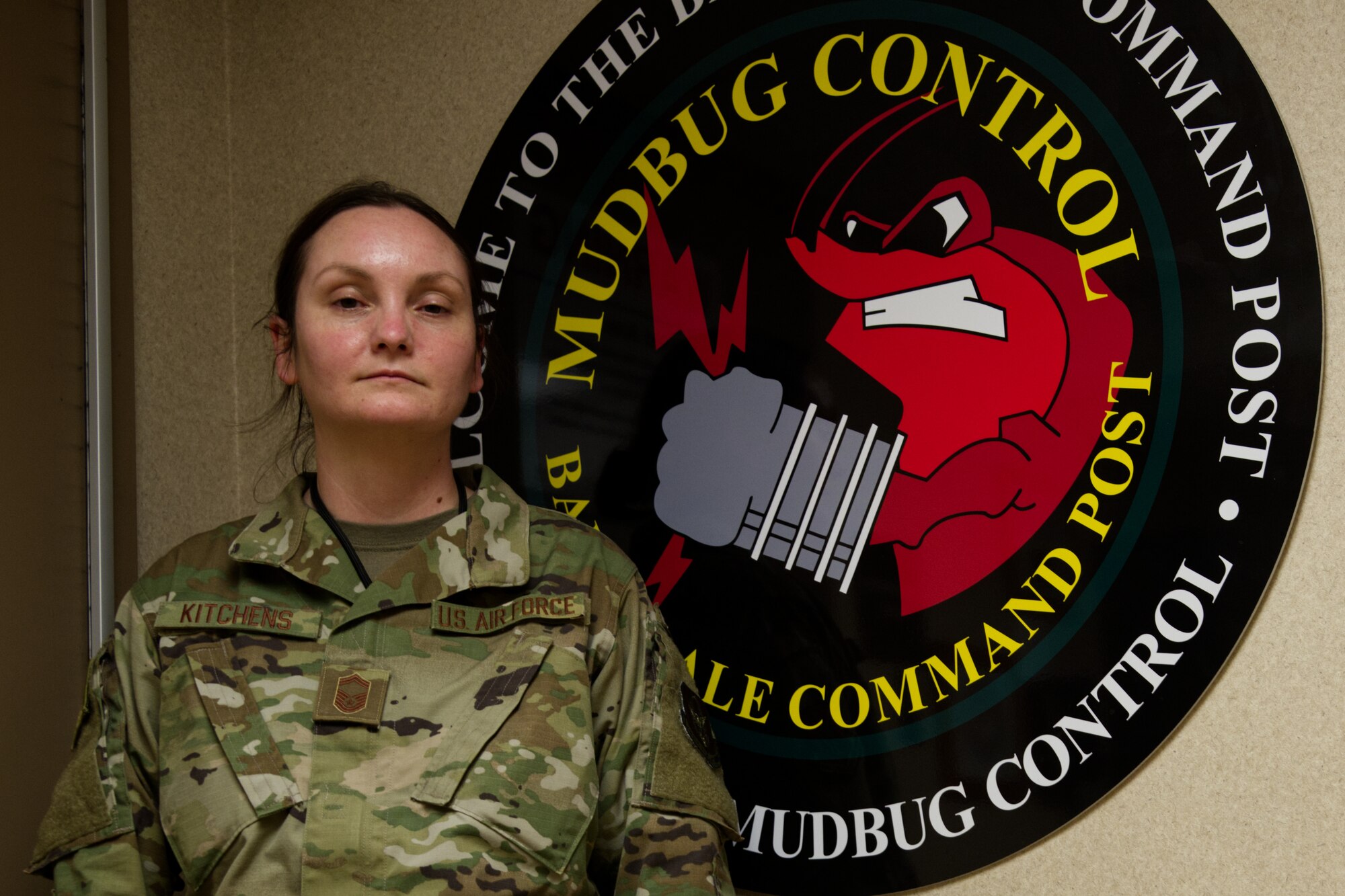 Photo of Airman by BAFB command post sign