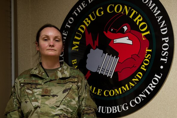 Photo of Airman by BAFB command post sign
