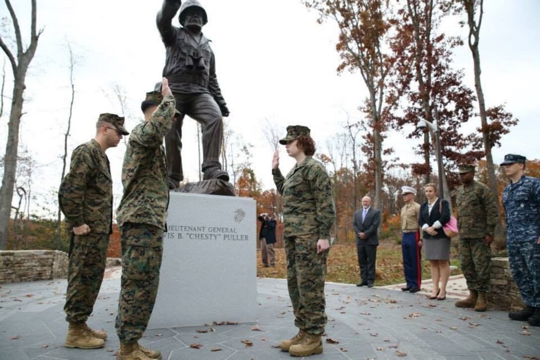 Corporal Tabitha Bartley reaffirms her oath to the country during her 2013 reenlistment ceremony. Bartley, a Lafayette, Ind., native choose the Chesty Puller monument located at the Marine Corps Museum in Quantico, Va., for Puller's importance to the corps. (Photo Courtesy of Tabitha Bartley)