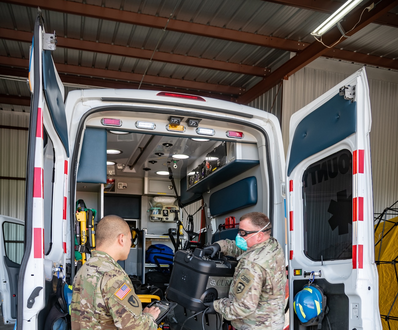 Members of the West Virginia National Guard perform COVID-19 decontamination of first responder vehicles with an Aerosolized Hydrogen Peroxide system at Yeager Airport, Charleston, West Virginia, April 14, 2020. The method will be used to sanitize more than 250 police vehicles and ambulances in the area.