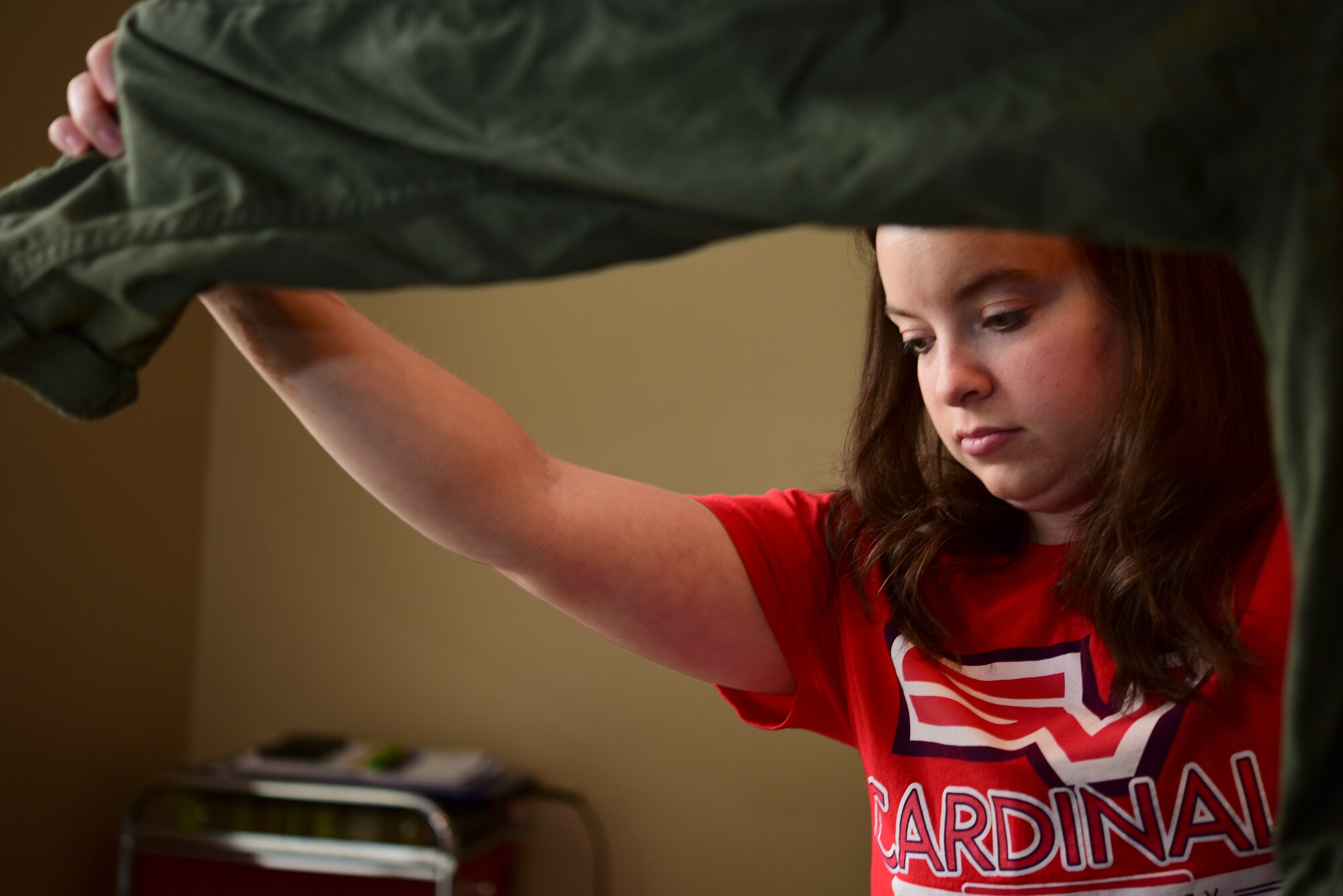 Mallory Albers, Science Technology Engineering Mathematics Magnet school special education teacher at Laughlin Air Force Base, Texas, organized uniforms to be cut up for face mask material on April 10, 2020. Albers says she is glad as a spouse to be helping out the military community through her sewing skills. (U.S. Air Force Photo by Senior Airman Anne McCready)