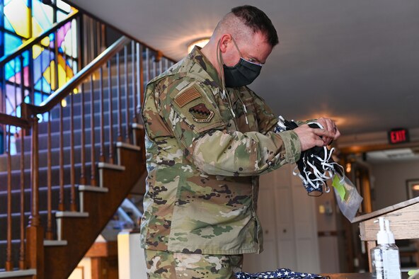 Staff Sgt. Chris Hillard, 66th Air Base Group Chapel religious affairs noncommissioned officer, organizes cloth face coverings made by local volunteers at Hansom Air Force Base, Mass., April 15. Representatives from the Hanscom Resilience Cell organized volunteers to sew face coverings from donated materials. (U.S. Air Force photo by Todd Maki)