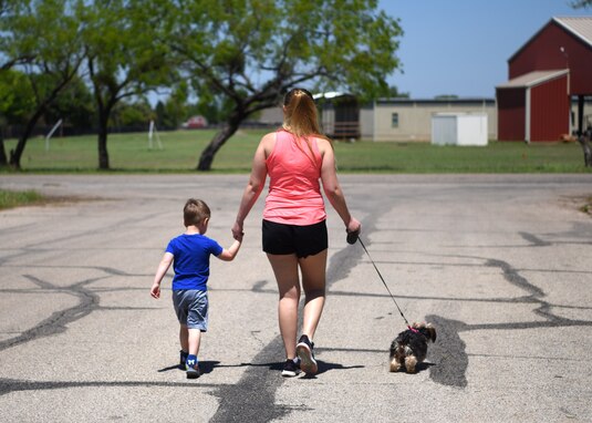Colby, 3,  and Sydney Sherwood take the family dog Wookiee for a walk in the neighborhood in San Angelo, Texas, April 16, 2020. Walking with Colby gave us valuable bonding time and wore him out enough for a nap. (U.S. Air Force photo by Airman 1st Class Ethan Sherwood)