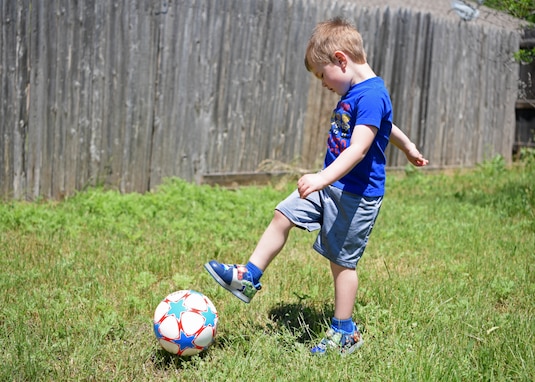 Colby, 3,  kicks a soccer ball towards the net while practicing for his team in San Angelo, Texas, April 16, 2020. Sports have taught Americans of all ages valuable life lessons about discipline and teamwork. (U.S. Air Force photo by Airman 1st Class Ethan Sherwood)