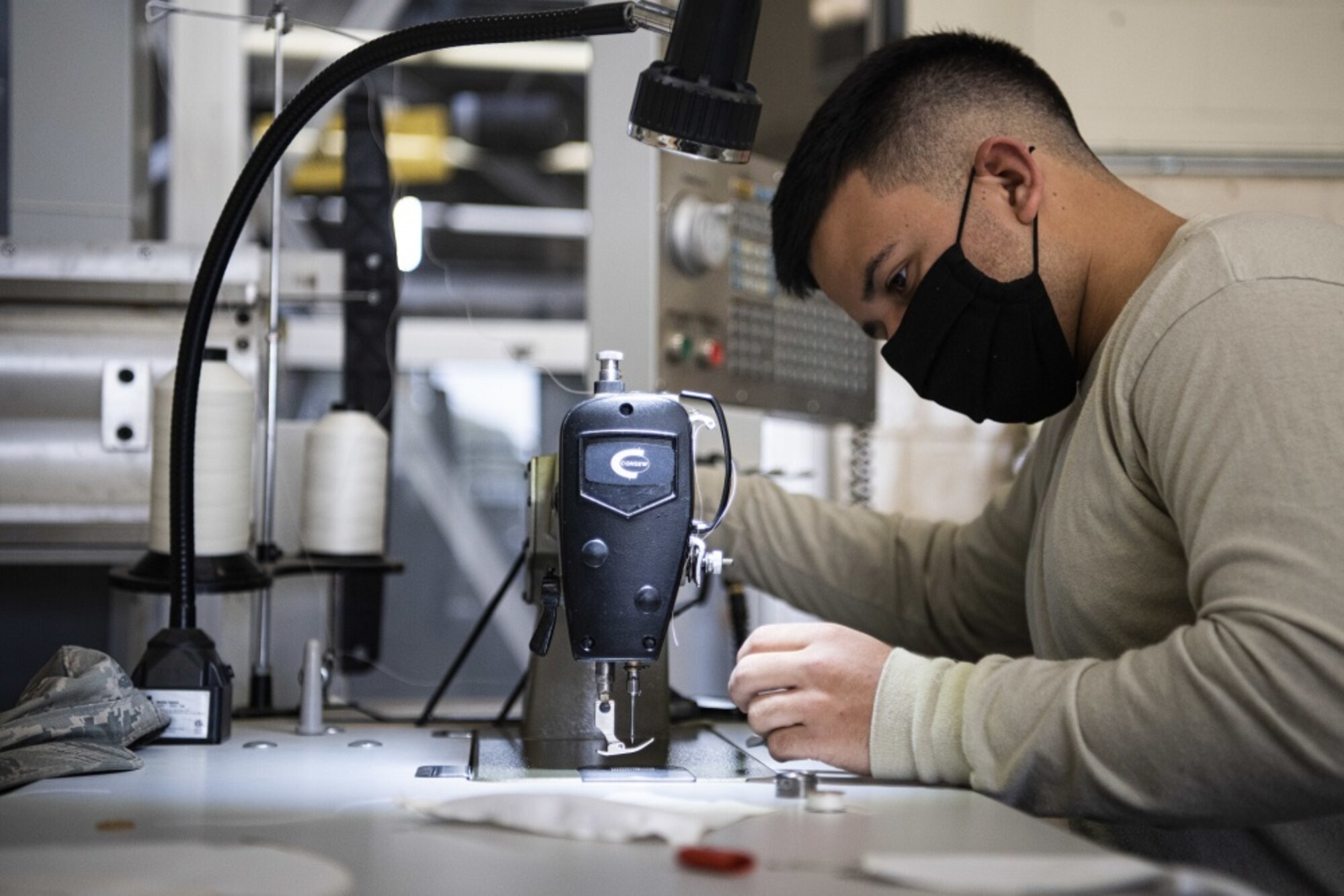 Senior Airman Miguel Garcia, 30th Operations Support Squadron intelligence analyst, sews masks for hospital workers and base members April 14, 2020, at Vandenberg Air Force Base, Calif. Garcia, and the group of volunteers plan to donate approximately 1,500 masks to members across Vandenberg AFB and roughly 150 masks to the local hospital in response to the COVID-19 pandemic. (U.S. Air Force photo by Airman 1st Class Hanah Abercrombie)