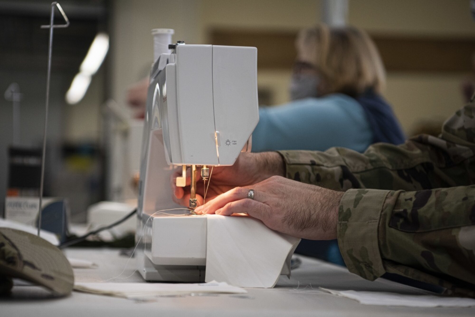 Capt. Daniel Smith, 30th Space Wing launch weather officer, sews masks for hospital workers and base members April 14, 2020, at Vandenberg Air Force Base, Calif. Volunteers from across base have utilized the Training Device Design and Engineering Center to sew masks during the COVID-19 pandemic. As of April 6, 2020, all base members are required to wear mask, so the volunteers began mass producing to help with the mask shortage. (U.S. Air Force photo by Airman 1st Class Hanah Abercrombie)