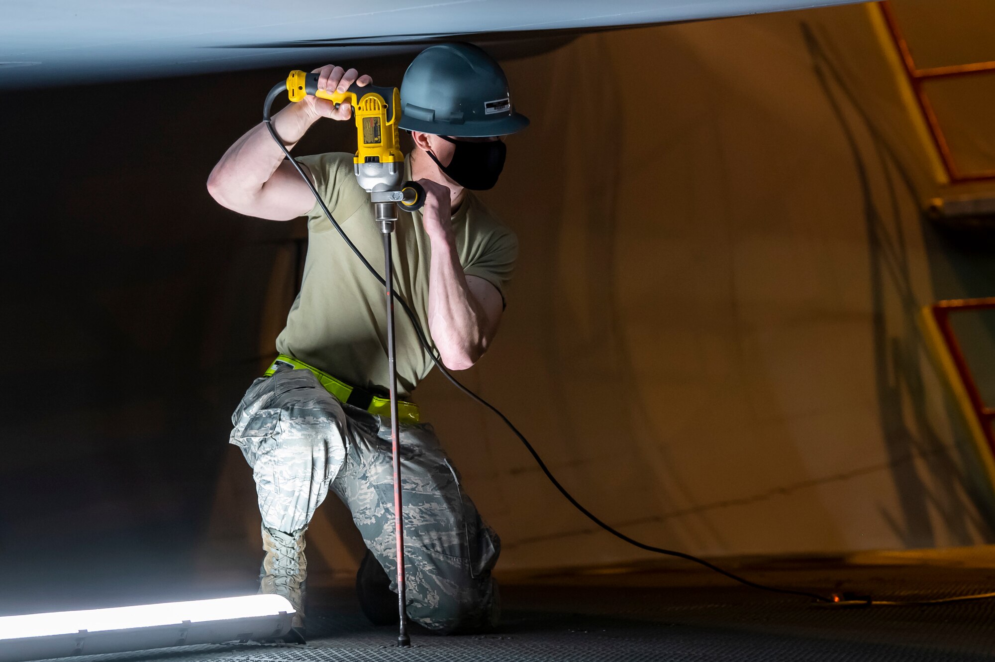 Airman 1st Class Robert Moody, 436th Maintenance Squadron C-5 regional isochronal apprentice, uses a stand-up drill to place stands close to the side of a C-5 Super Galaxy engine at Dover Air Force Base, Delaware, April 9, 2020.  Moody wears a cloth mask  in accordance with Department of Defense instruction to mitigate the spread of COVID-19. (U.S. Air Force photo by Senior Airman Christopher Quail)