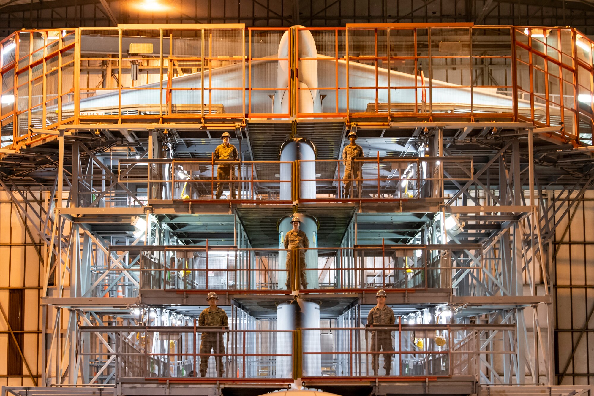 Five 436th Maintenance Squadron aircraft maintenance personnel pose for a group photo in the Isochronal Inspection Dock on Dover Air Force Base, Delaware, April 10, 2020. Dover AFB maintenance personnel continue to support operations despite significantly reduced manning and increased health protection measures such as wearing cloth masks, social distancing, and wash or sanitizing hands frequently to mitigate the spread of COVID-19. (U.S. Air Force photo by Senior Airman Christopher Quail)