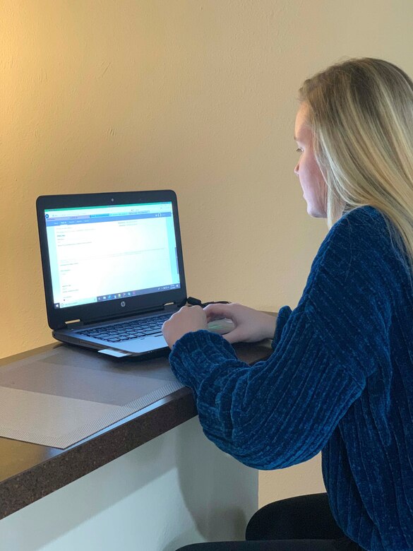 U.S. Air Force Airman 1st Class Megan Rowlett, 633rd Contracting Squadron contract specialist, signs her first contract as a warranted contracting officer for the purchase COVID-19 testing modules from her home in Hampton, Virginia, March 30, 2020.