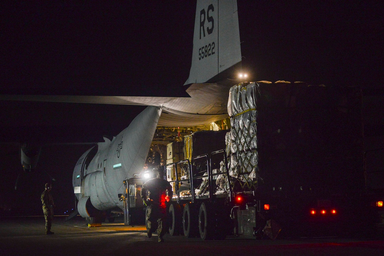A vehicle is loaded with cargo from an aircraft.
