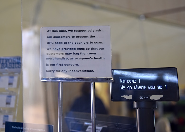 A sign at the check out in the Base Exchange explains new procedures for scanning objects and bagging on Goodfellow Air Force Base, Texas, April 16, 2020. Due to COVID-19 the Exchange is implementing new precautions to help lesson contact during transactions. (U.S. Air Force photo by Senior Airman Seraiah Wolf)