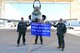 A photo of Airmen posing with a flag