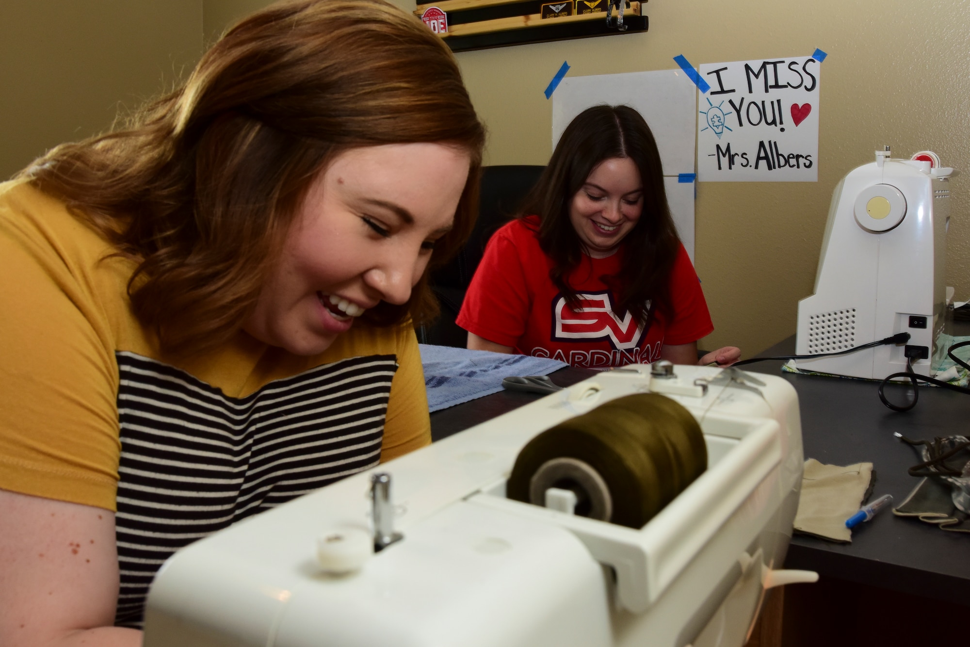 Chelsea Truster, St. James Episcopal Pre-K teacher and Laughlin spouse, and Mallory Albers, Science Technology Engineering Mathematics Magnet school special education teacher at Laughlin Air Force Base, Texas, team up to sew reusable face masks that match Airmen’s uniforms on April 10, 2020. Both Truster and Albers got their first sewing machines when they were in their teens. While neither of them consider themselves a seamstress, they worked on sewing projects before such as quilts. (U.S. Air Force Photo by Senior Airman Anne McCready)