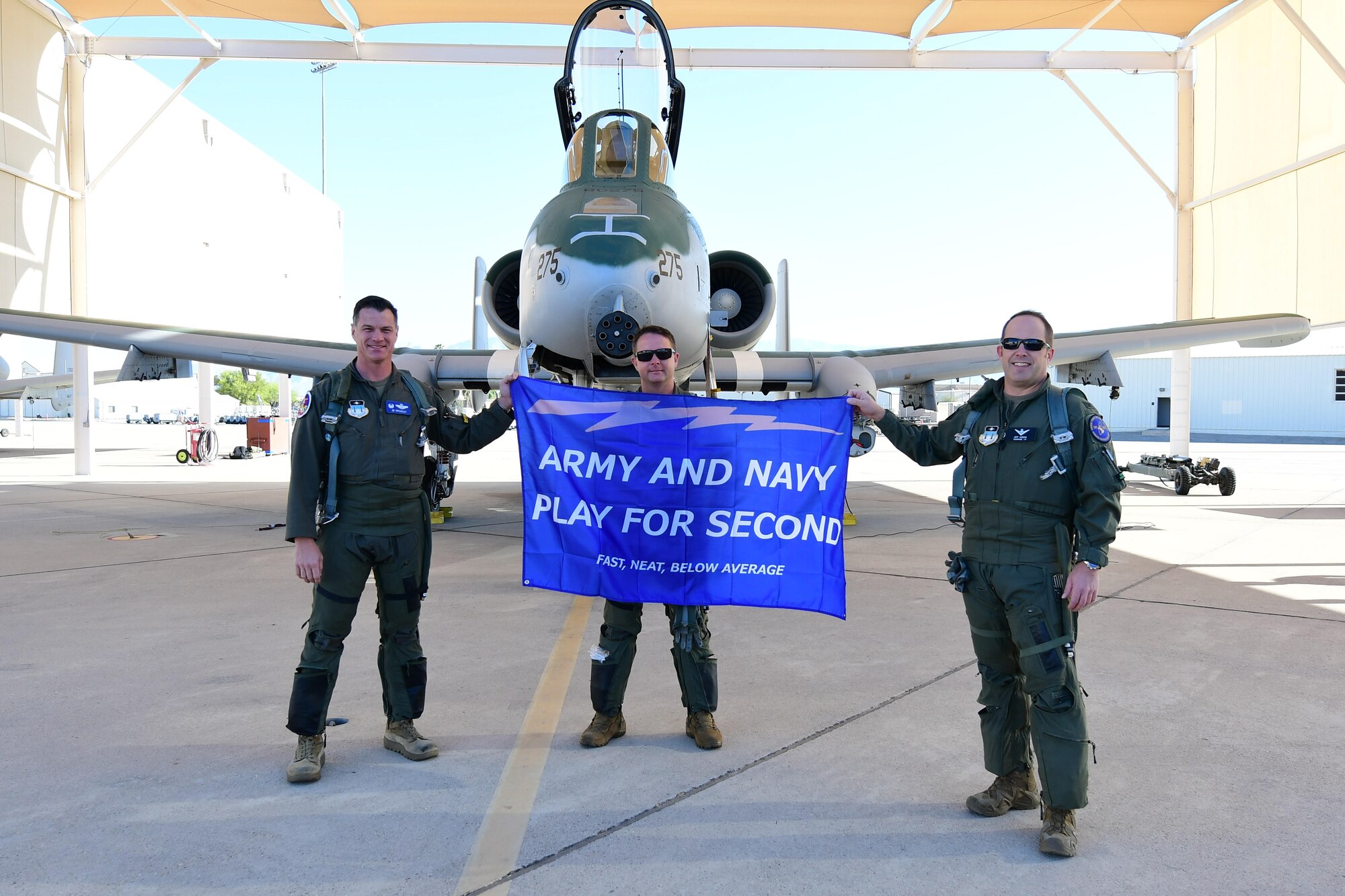A photo of Airmen posing with a flag