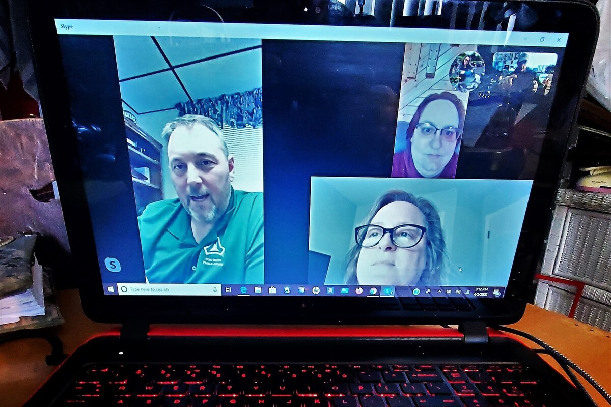 A screenshot shows the faces of people on a teleconference.