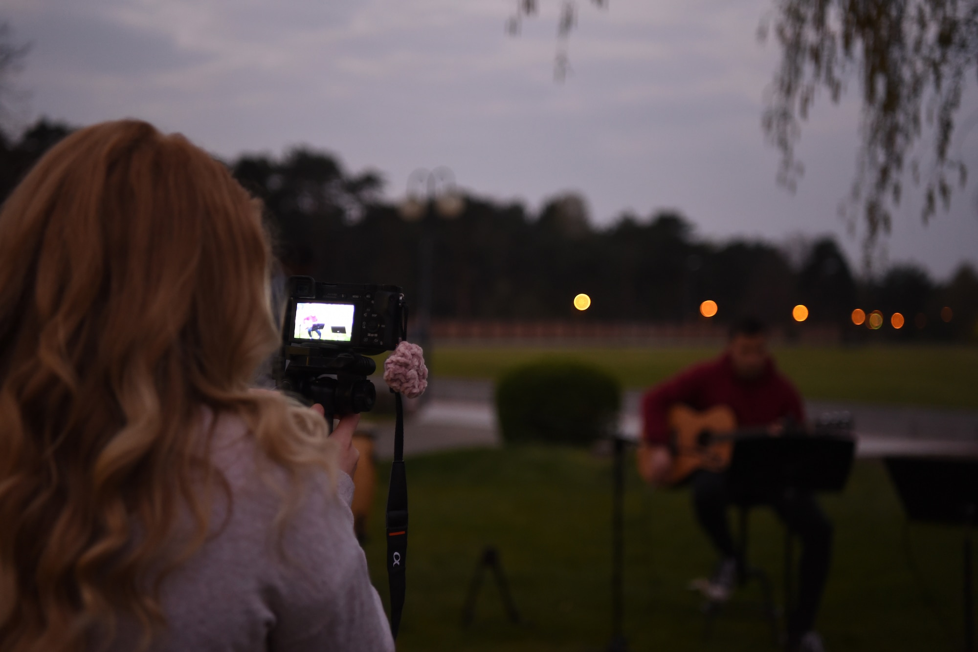 A member of the Contemporary Service Worship Team sets up a camera to record outside the Northside Chapel at Ramstein Air Base, Germany, April 9, 2020.