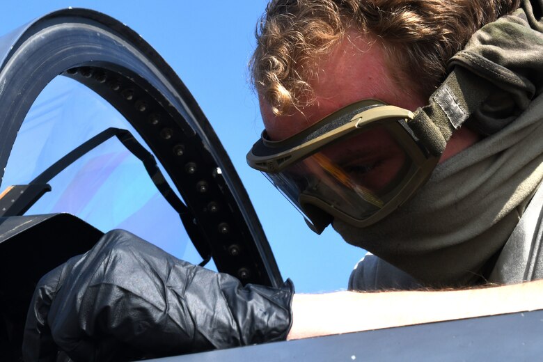 A 494th Aircraft Maintenance Unit crew chief cleans the cockpit of an F-15E Strike Eagle to prevent the spread of COVID-19 at Royal Air Force Lakenheath, England, April 16, 2020. Crew chiefs are required to take safety precautions to help protect themselves and other aircrew who may come in contact with the aircraft. (U.S. Air Force photo by Senior Airman Christopher S. Sparks)