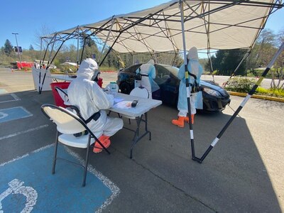 Washington National Guard Airmen deployed from the 141st Air Refueling Wing at Fairchild Air Force Base in Spokane assist a patient testing for COVID-19 in Aberdeen, Wash., April 16, 2020.