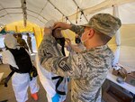 Airmen deployed from the 141st Air Refueling Wing at Fairchild Air Force Base in Spokane prepare to start a shift in the testing tent at a COVID-19 community-based testing site in Aberdeen, Wash., April 16, 2020.