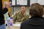 Command Sgt. Maj. Brian Webb, the senior enlisted leader for the North Carolina National Guard’s 60th Troop Command, listens to a University of North Carolina Healthcare System employee during a conference call at the North Carolina Emergency Management’s Orange County Branch Office, April 15, 2020, where he is working as a liaison between the branch and the NCNG.