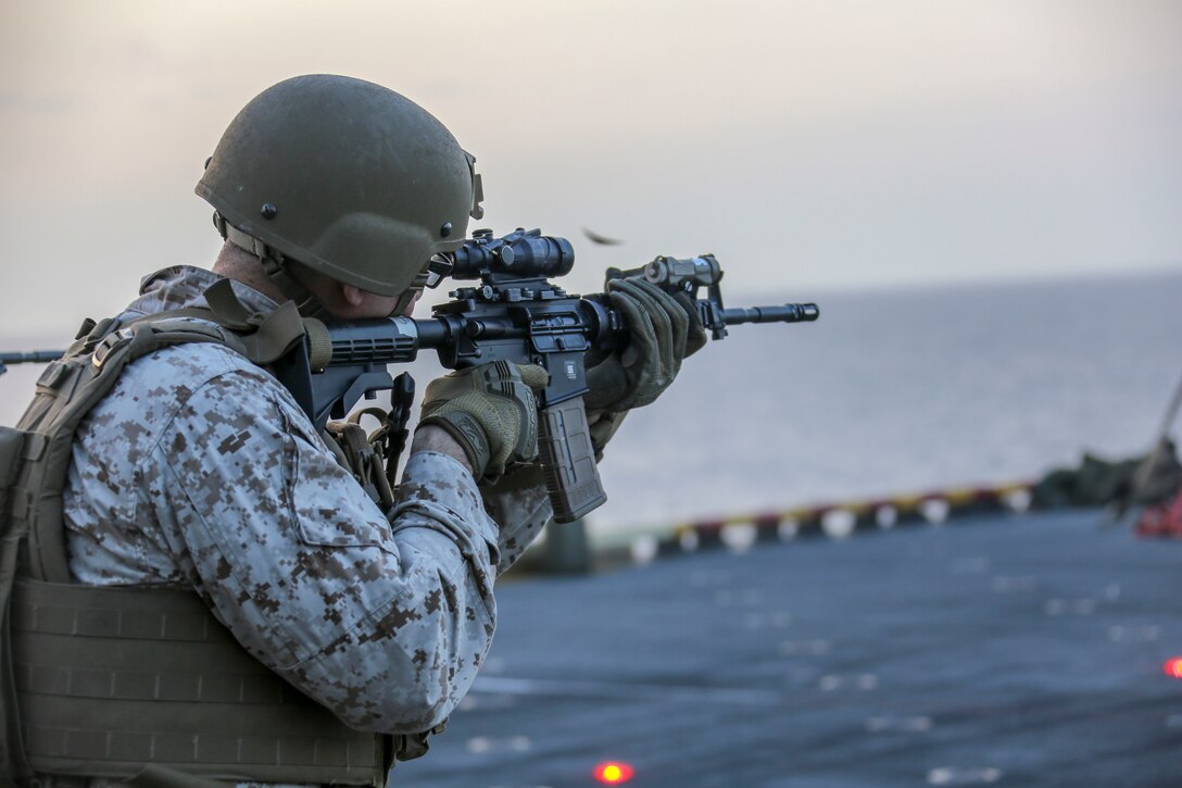200416-M-OO419-1010 U.S. 5TH AREA OF OPERATIONS (April 16, 2020) Lance Cpl. Gabriel Carlin, combat engineer, assigned to Headquarters and Service Company, Battalion Landing Team 2/8, 26th Marine Expeditionary Unit (MEU), fires an M4 carbine during a live-fire training range aboard the amphibious assault ship USS Bataan (LHD 5) April 16, 2020. Bataan, with embarked 26th MEU, is deployed to the U.S. 5th Fleet area of operations in support of naval operations to ensure maritime stability and security in the Central Region, connecting the Mediterranean and Pacific through the Western Indian Ocean and three strategic choke points. (U.S. Marine Corps photo by Cpl. Nathan Reyes)