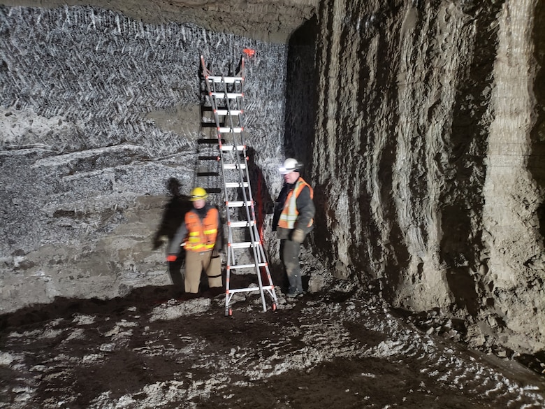 CRREL technician Kate Liddle-Broberg and contractor Ken Robbins finish marking the mining face for excavation control of the Engineer Cold Regions Research and Engineering Laboratory's Permafrost Tunnel Research Facility in Fox, Alaska, as part of the phase four expansion of the permafrost tunnel, which excavated a 300 foot tunnel and improved 200 feet of pre-existing tunnel.