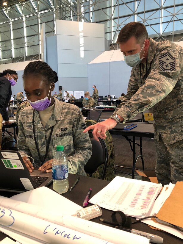 Senior Master Sgt. Michael B. Moody, 64th AEG first sergeant, oversees Staff Sgt Awa B. Diakhate, 64th AEG PERSCO, April 8, 2020. They were both forward deployed to the Javits Center in NYC to help fight against COVID-19. Moody is a packaging specialist with the Construction and Equipment supply chain at Defense Logsistics Agency Troop Support in Philadelphia.