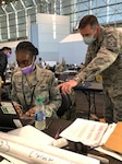Senior Master Sgt. Michael B. Moody, 64th AEG first sergeant, oversees Staff Sgt Awa B. Diakhate, 64th AEG PERSCO, April 8, 2020. They were both forward deployed to the Javits Center in NYC to help fight against COVID-19. Moody is a packaging specialist with the Construction and Equipment supply chain at Defense Logsistics Agency Troop Support in Philadelphia.