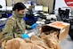 Staff Sgt. Mia Blakley sifting through packaging of a box.