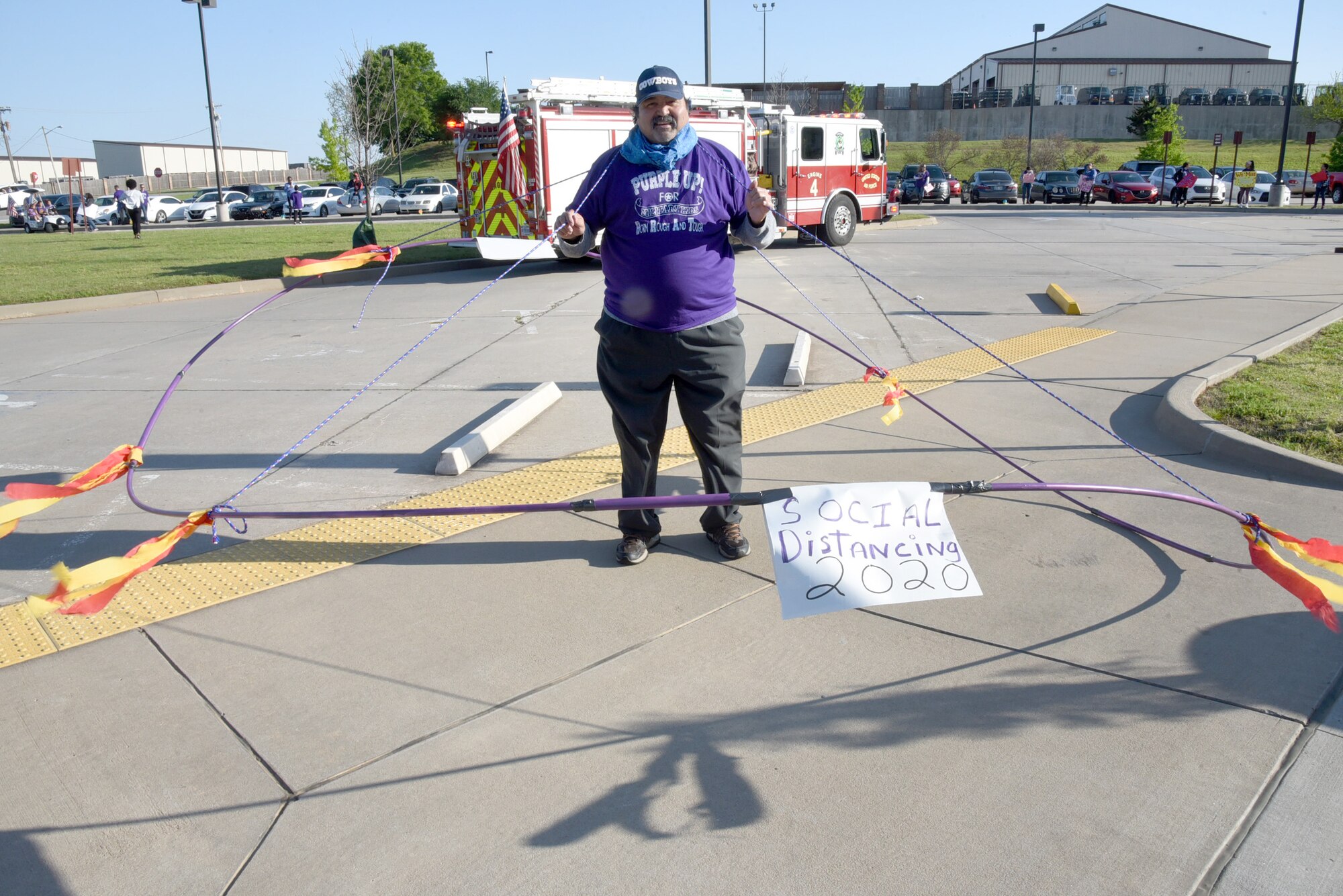 Juan Flores, Violence Prevention Integrator with the 72nd Air Base Wing, demonstrates proper social distancing during an inverse parade held April 16, 2020, at Child Development Center South.