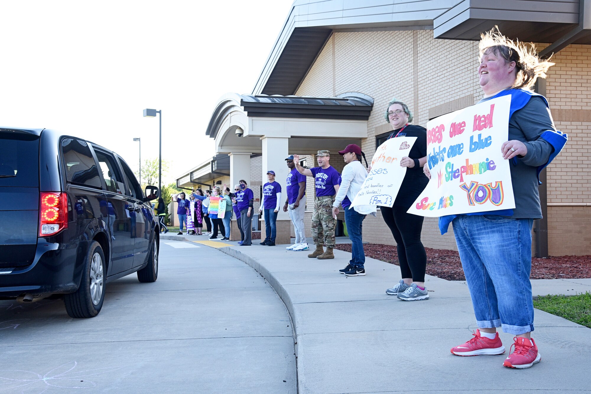 Teachers from the Child Development Center South anxiously await the arrival of their students and their families during a Month of the Military Child Parade April 16, 2020.
