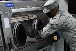 An Airman assigned to the New York National Guard's 24th Civil Support Team conducts a COVID-19 test analysis at the Javits New York Medical Station in New York City April 16, 2020. The 22 members of the 24th CST, who train to detect biological and chemical hazards, are providing COVID-19 testing to medical personnel at the site.