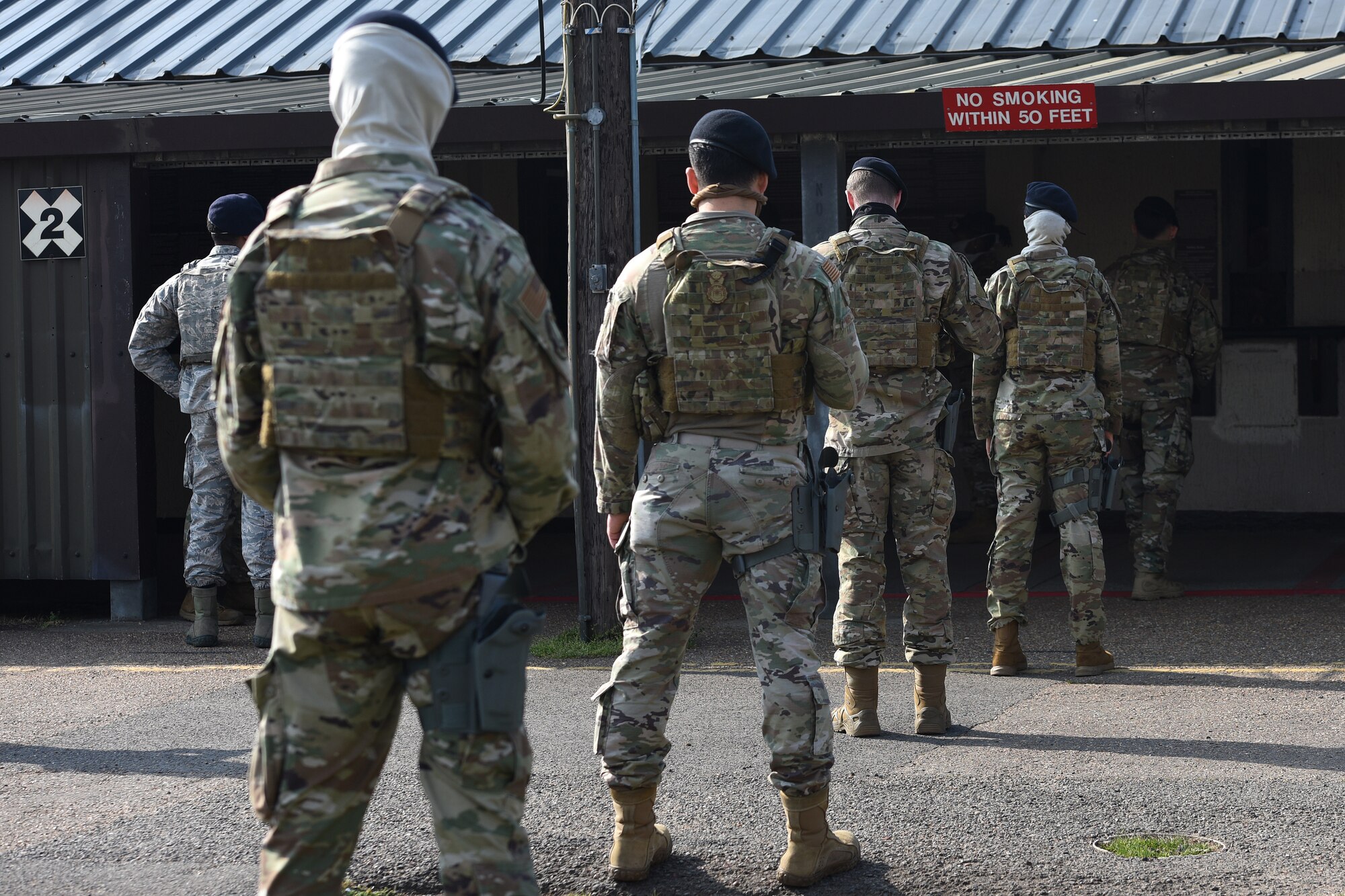 48th Security Forces Squadron Airmen apply social distancing procedures as they line up for weapon issuing at Royal Air Force Lakenheath, England, April 16, 2020. The 48th SFS Defenders have taken preventative measures to combat the spread of COVID-19 as they continue to protect the Liberty Wing community and maintain mission readiness. (U.S. Air Force photo by Airman 1st Class Jessi Monte)