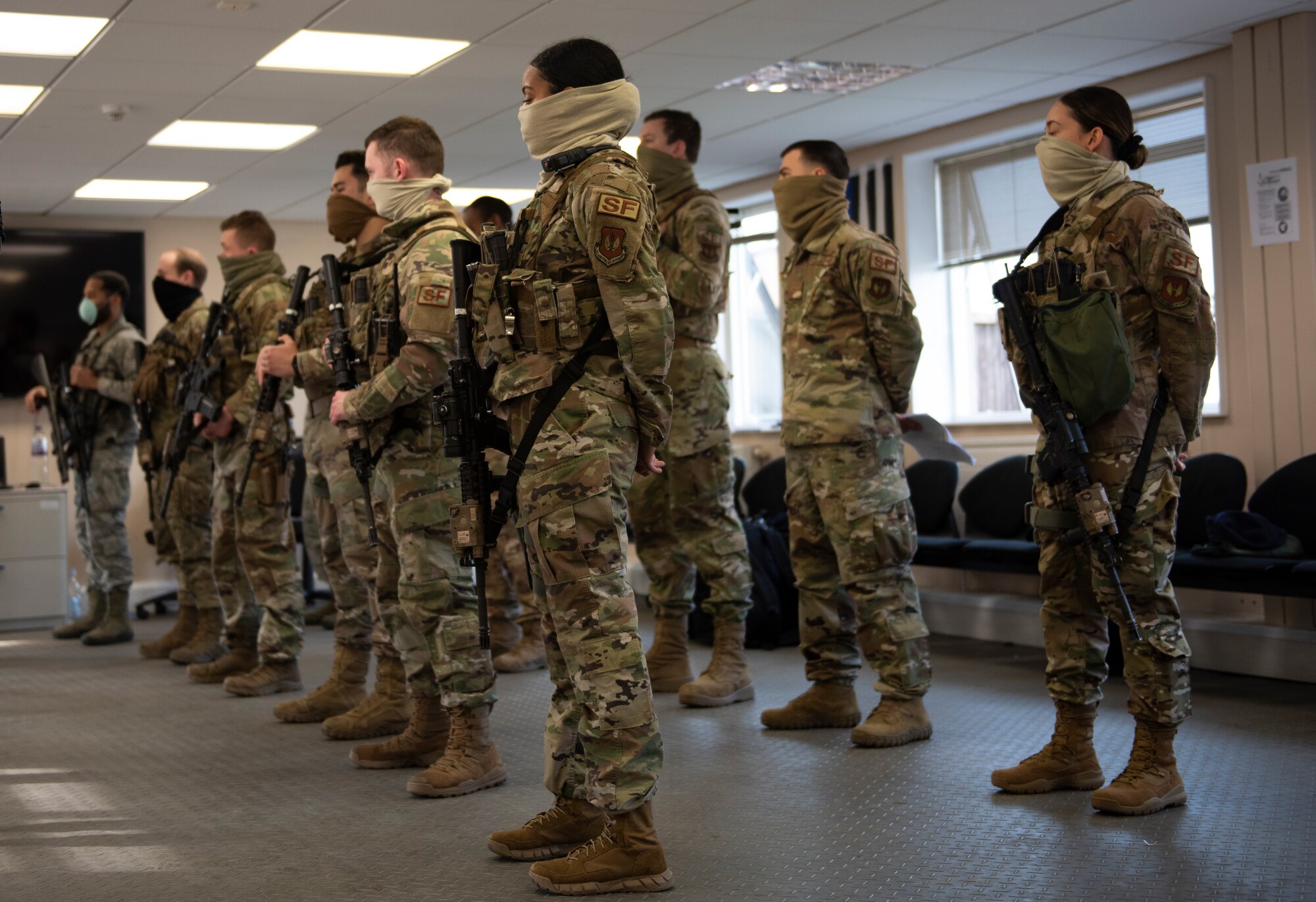 48th Security Forces Squadron Airmen apply social distancing procedures during a pre-shift briefing at Royal Air Force Lakenheath, England, April 16, 2020. The squadron has taken preventative measures to combat the spread of COVID-19 as they continue to protect and defend U.S. Air Forces in Europe’s largest fighter wing. (U.S. Air Force photo by Airman 1st Class Jessi Monte)