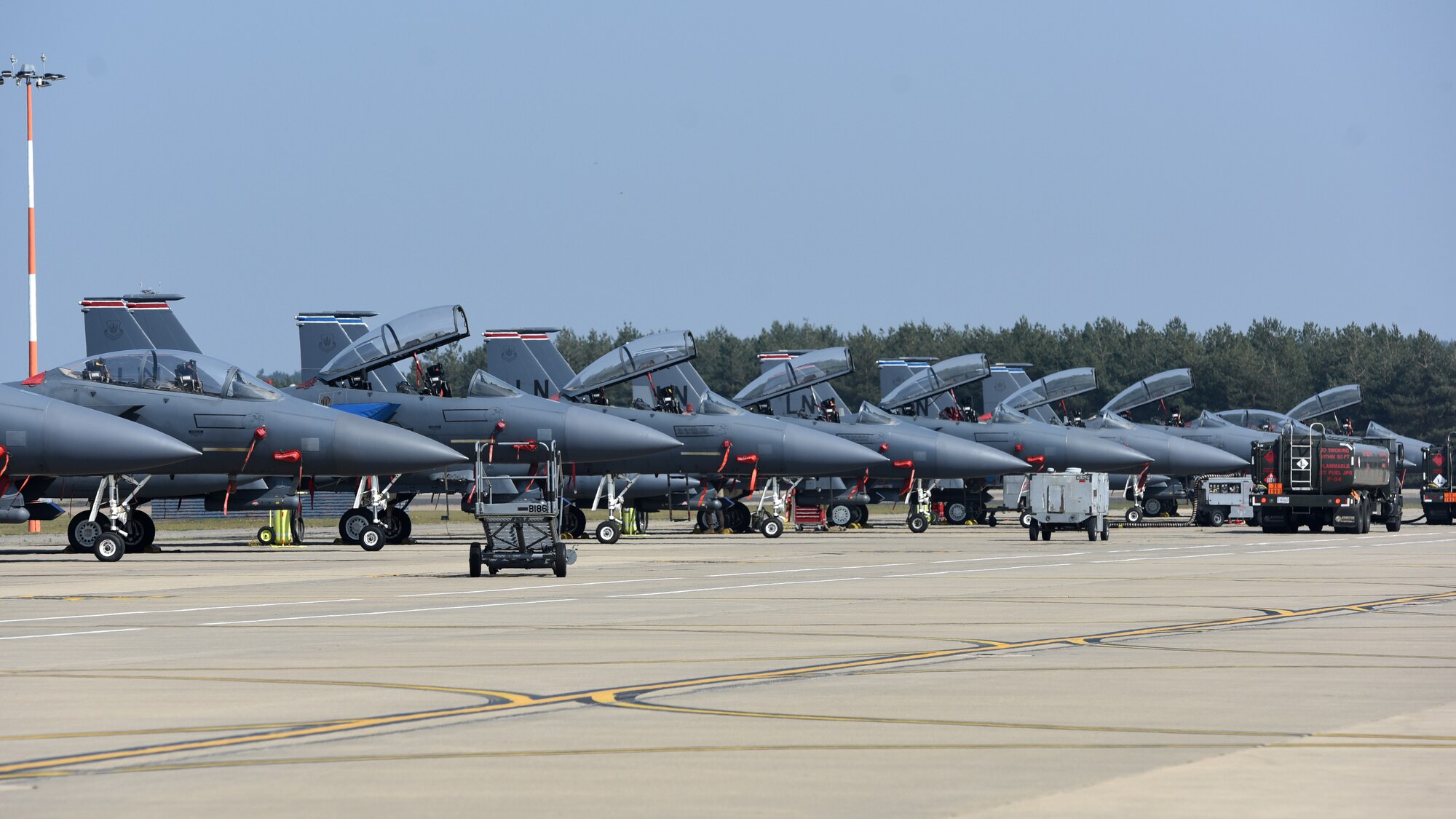 F-15E Strike Eagles assigned to the 492nd and 494th Fighter Squadrons line the taxiway at Royal Air Force Lakenheath, England, April 16, 2020. Both squadrons are combat-ready, world-wide deployable units capable of executing strategic attack, interdiction, close air support and counter-air missions in support of war plans and contingency operations for U.S European Command, U.S. Africa Command and NATO. (U.S. Air Force photo by Airman 1st Class Jessi Monte)