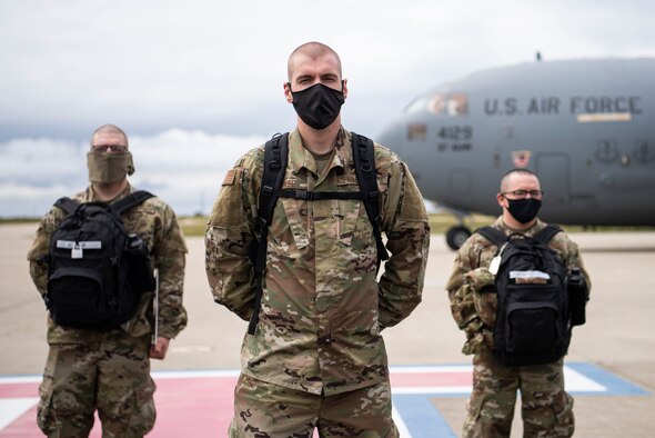 Airmen arriving from Basic Military Training are greeted by Chief Master Sgt. Darryl Hogan, 30th Space Wing command chief, April 17, 2020, at Vandenberg Air Force Base, Calif. In order to safely route members from BMT during the COVID-19 pandemic, the Airmen were flown on a C-17 to the flightline at Vandenberg AFB, and later bussed to their technical school locations. Each Airmen went through a 14-day quarantine process at Joint Base San Antonio-Lackland, Texas, prior to flying on the C-17. (U.S. Air Force photo by Senior Airman Aubree Owens)