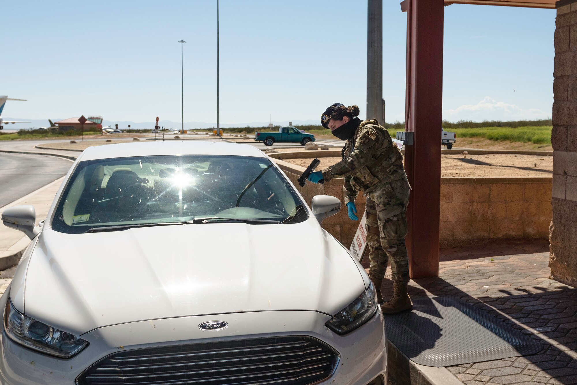 Airman 1st Class Jade Groelinger, 412th Security Forces Squadron, 412th Test Wing at Edwards Air Force Base, California, scans an identification card at the West gate at Edwards AFB, April 16. (Photo by Richard Gonzales).