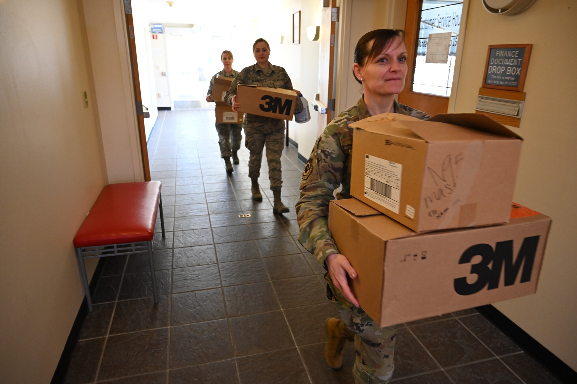 carrying boxes of masks