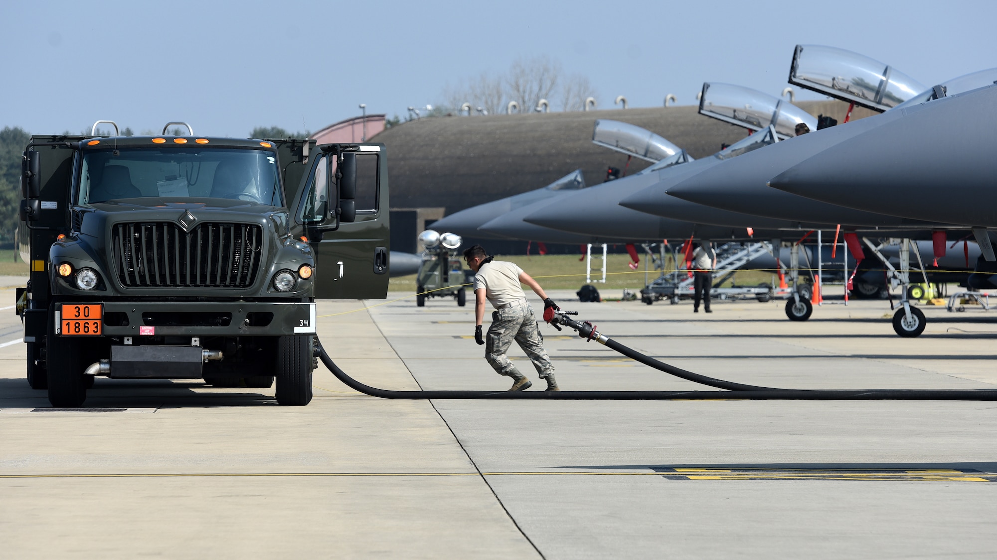 A Liberty Wing Airman finishes refueling an F-15E Strike Eagle at Royal Air Force Lakenheath, England, April 16, 2020. Despite the current COVID-19 crisis, the 48th Fighter Wing has a commitment to be ready to deliver combat air power when called upon by U.S. Air Forces in Europe-Air Forces Africa. (U.S. Air Force photo by Airman 1st Class Jessi Monte)